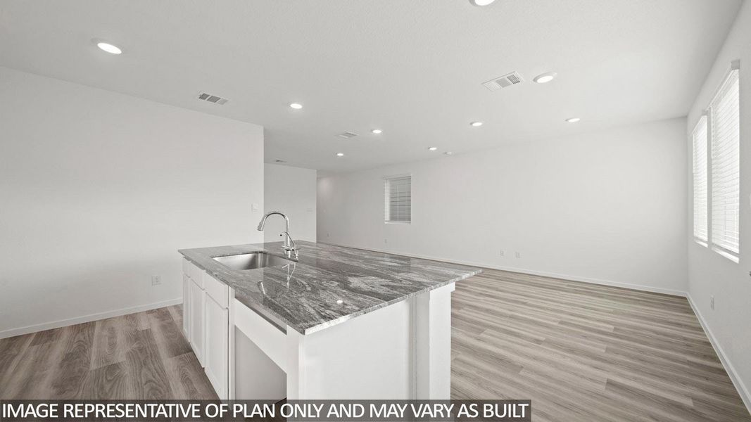 Kitchen island featuring a stainless steel sink and a contemporary gooseneck faucet