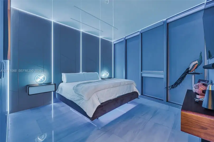 Custom-paneled wall with integrated vertical LED lighting, expansive floor-to-ceiling windows, and polished stone flooring Custom-paneled wall with integrated vertical LED lighting, expansive floor-to-ceiling windows, and polished stone flooring