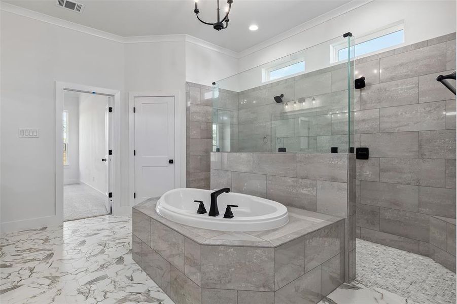 Bathroom featuring crown molding, shower with separate bathtub, and tile patterned floors