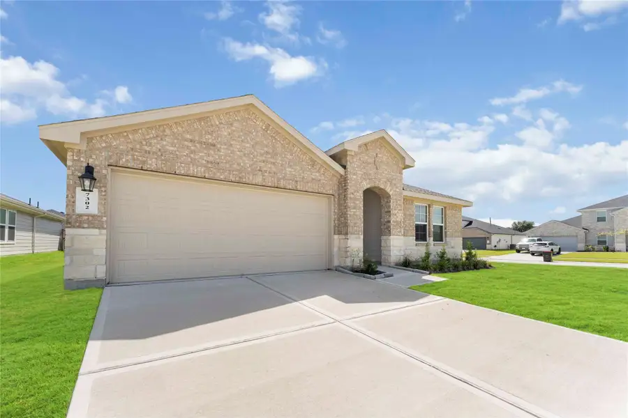 Two-car garage, a pristine lawn, and a spacious driveway, nestled in a beautiful neighborhood. Two-car garage, a pristine lawn, and a spacious driveway, nestled in a beautiful neighborhood.