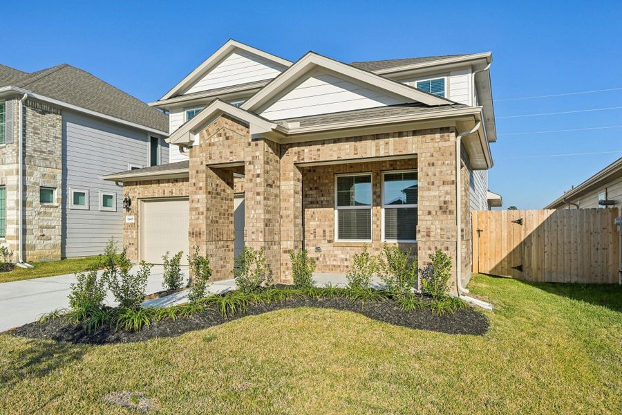Front exterior of a new home in Landing Meadows - Premier Series, New Caney, TX, highlighting curb appeal (Image 19).