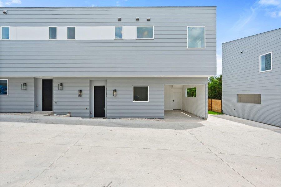 The property features a modern exterior with light grey siding and white trim windows