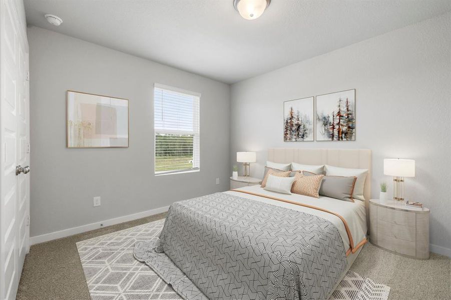 Secondary bedroom features plush carpet, neutral paint, large window and ample closet space.