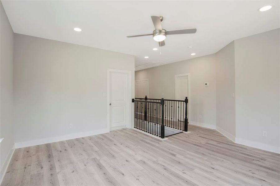 Another view of the game room.. door on the far left is to a secondary bedroom. Door in the middle is to the bathroom, door to the far left is to the utility room. The other 2 secondary bedrooms are to the far right of the picture and the other side of the utility room.