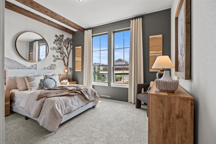 Carpeted bedroom with beam ceiling