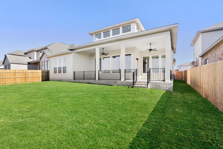 Back of house with a ceiling fan, a porch, and a fenced backyard Back of house with a ceiling fan, a porch, and a fenced backyard