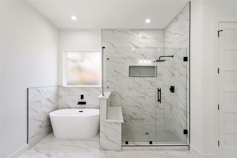 Indulge in elegance with a sleek standalone tub and a spacious walk-in shower.