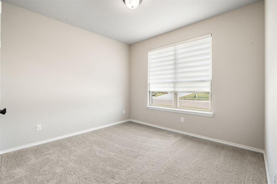 Carpeted empty room featuring baseboards Carpeted empty room featuring baseboards