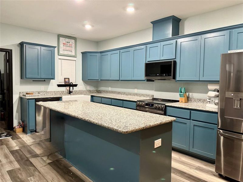 Kitchen opens to living room, dining area and flex space