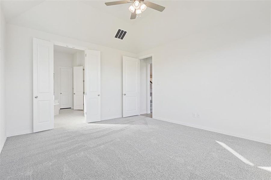 Unfurnished bedroom with ceiling fan and light carpet