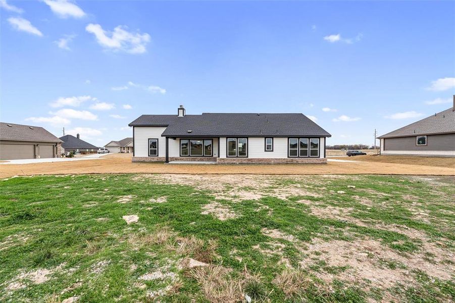 Rear view of property with a chimney and a yard