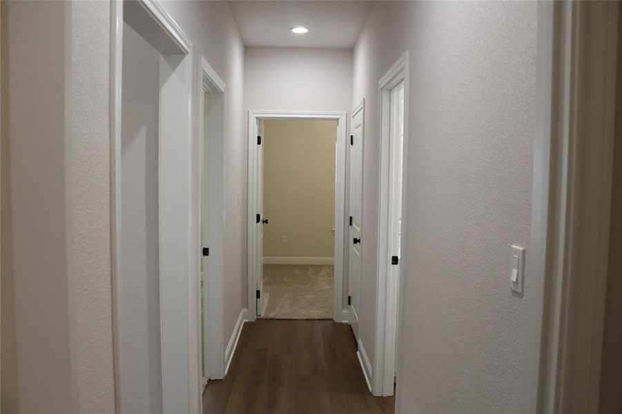 Hallway featuring dark wood-style flooring, baseboards, and recessed lighting Hallway featuring dark wood-style flooring, baseboards, and recessed lighting