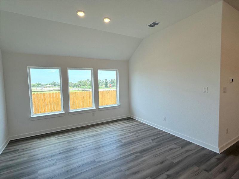 Unfurnished room featuring lofted ceiling, dark wood-style flooring, and recessed lighting