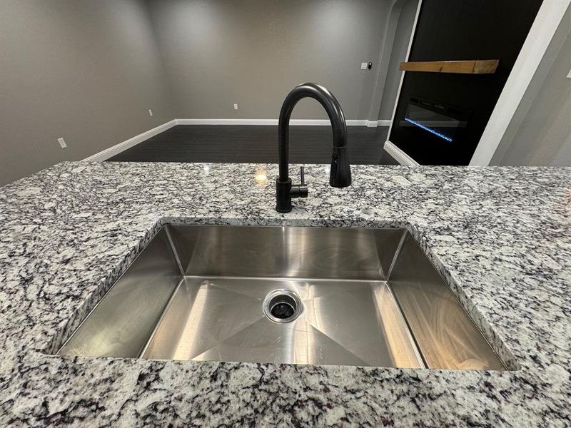 Interior details featuring light stone counters and sink