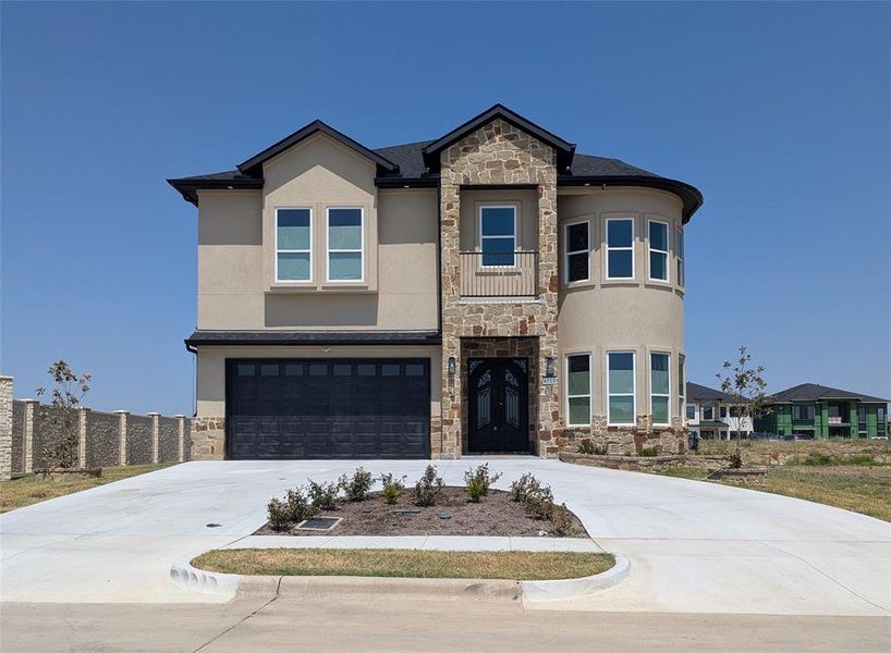 View of front of property featuring a garage