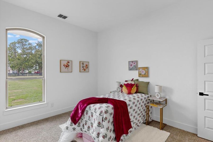 Carpeted bedroom featuring baseboards