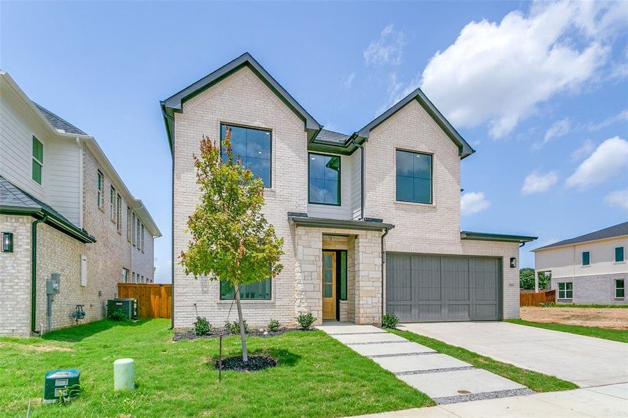 View of front facade with concrete driveway, brick siding, and a garage View of front facade with concrete driveway, brick siding, and a garage
