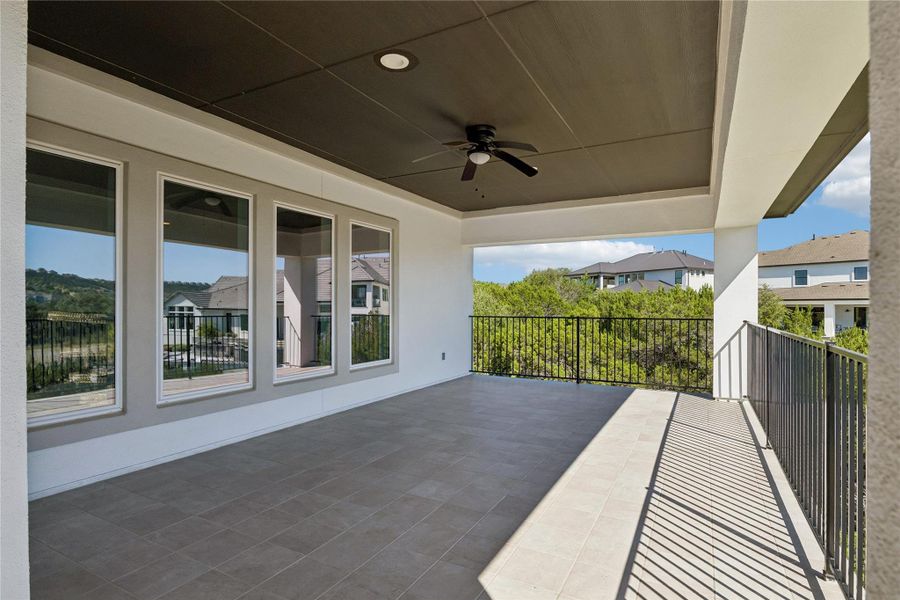 An inviting covered patio offers tiled flooring and panoramic views of the surrounding landscape.