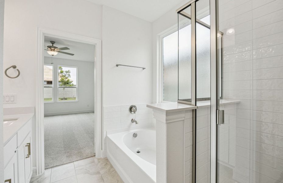 Modern owner's bath with dual vanities and a spacious shower  *Real home pictured