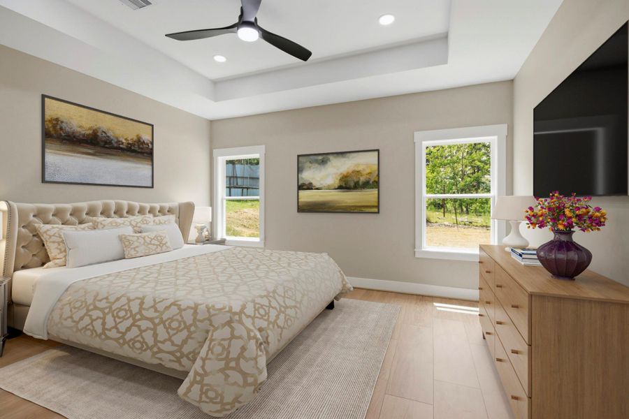 Virtually Staged: The sprawling primary suite serves as a serene sanctuary, complete with an elegant architectural tray ceiling, warm light-toned flooring, modern recessed lighting, a contemporary ceiling fan. Virtually Staged: The sprawling primary suite serves as a serene sanctuary, complete with an elegant architectural tray ceiling, warm light-toned flooring, modern recessed lighting, a contemporary ceiling fan.