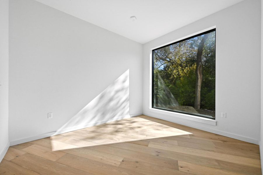 Unfurnished room with light wood-type flooring and baseboards Unfurnished room with light wood-type flooring and baseboards