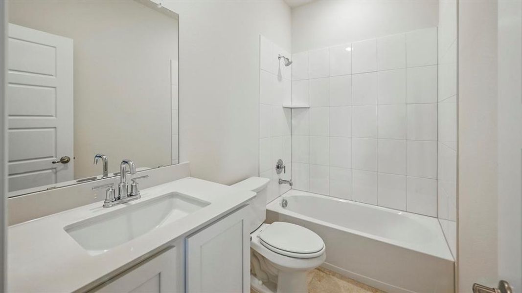 Full bathroom featuring a white vanity with an integrated sink, polished chrome faucet, and a large wall-mounted mirror