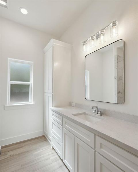 Bathroom with hardwood / wood-style floors and vanity