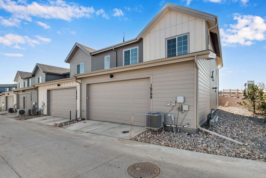 Front exterior of a new home in Candelas Townhomes, Arvada, CO, highlighting curb appeal (Image 21).