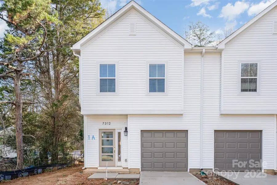 Front exterior of a new home in , Charlotte, NC, highlighting curb appeal (Image 1).