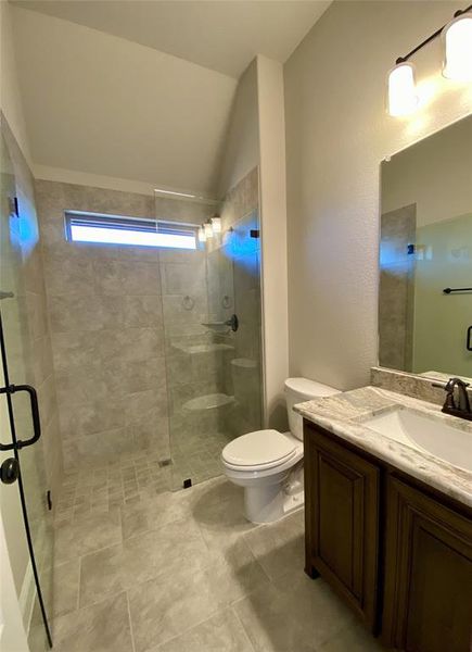 Bath 2 downstairs offers walk-in shower, framless glass, granite vanity, 12x24 tile, and a window for natural light.