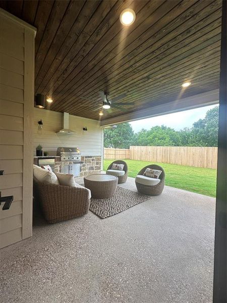 Covered patio featuring a wood-finish ceiling, recessed lighting, and a ceiling fan