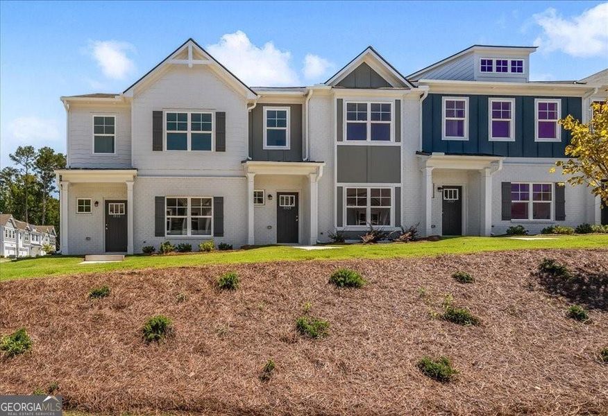 Front exterior of a new home in Shoals Crossing, Conyers, GA, highlighting curb appeal (Image 2). Front exterior of a new home in Shoals Crossing, Conyers, GA, highlighting curb appeal (Image 2).