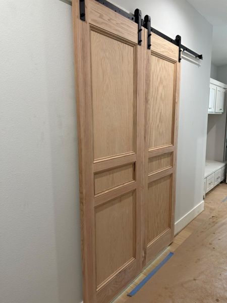 Detailed view of a barn door and baseboards