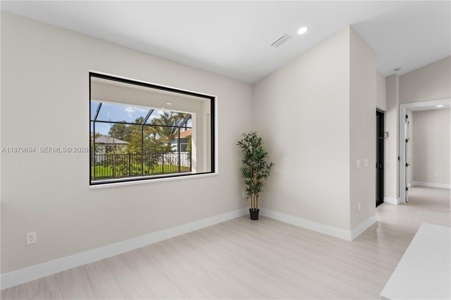 LARGE PICTURE WINDOW brings in natural light & offers views of screened lanai & backyard. LARGE PICTURE WINDOW brings in natural light & offers views of screened lanai & backyard.