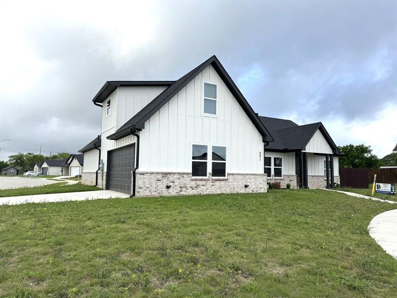 Front exterior of a new home in , Godley, TX, highlighting curb appeal (Image 1). Front exterior of a new home in , Godley, TX, highlighting curb appeal (Image 1).