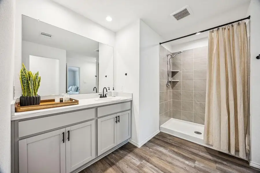 Elegant primary bathroom featuring a spacious walk-in shower, stylish vanity with ample storage, and modern fixtures for a luxurious feel. Elegant primary bathroom featuring a spacious walk-in shower, stylish vanity with ample storage, and modern fixtures for a luxurious feel.