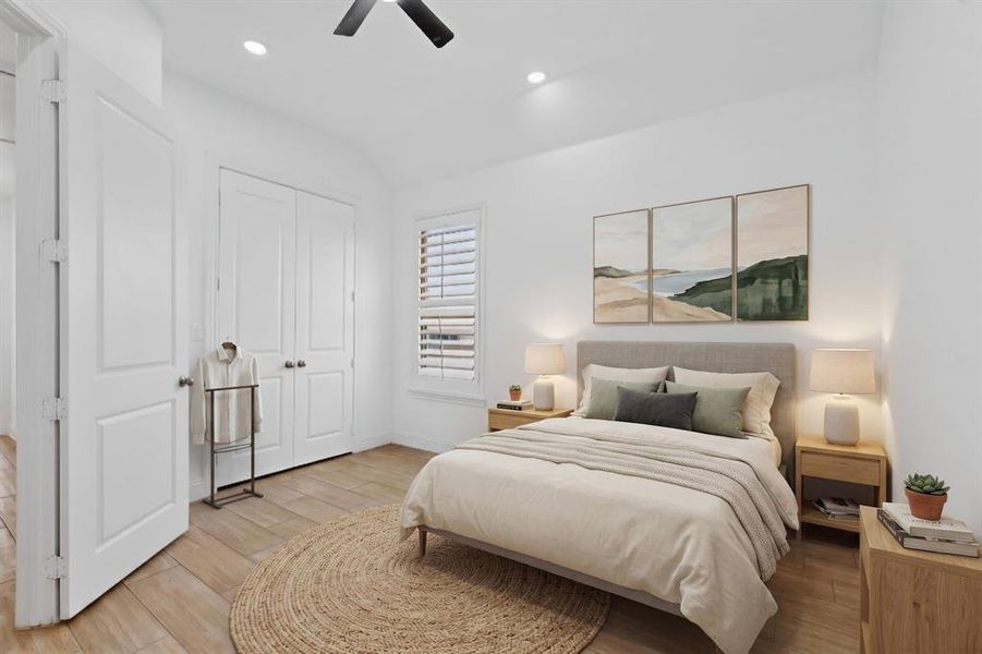 Recessed lighting illuminates a space featuring wood-finish flooring, a ceiling fan, and a window with louvered shutters Recessed lighting illuminates a space featuring wood-finish flooring, a ceiling fan, and a window with louvered shutters