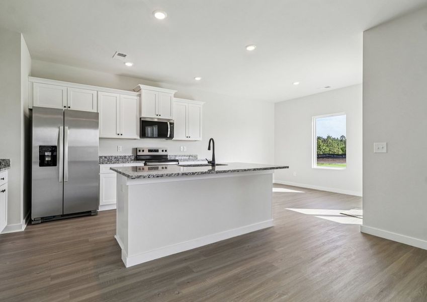 The kitchen has designer wood cabinetry