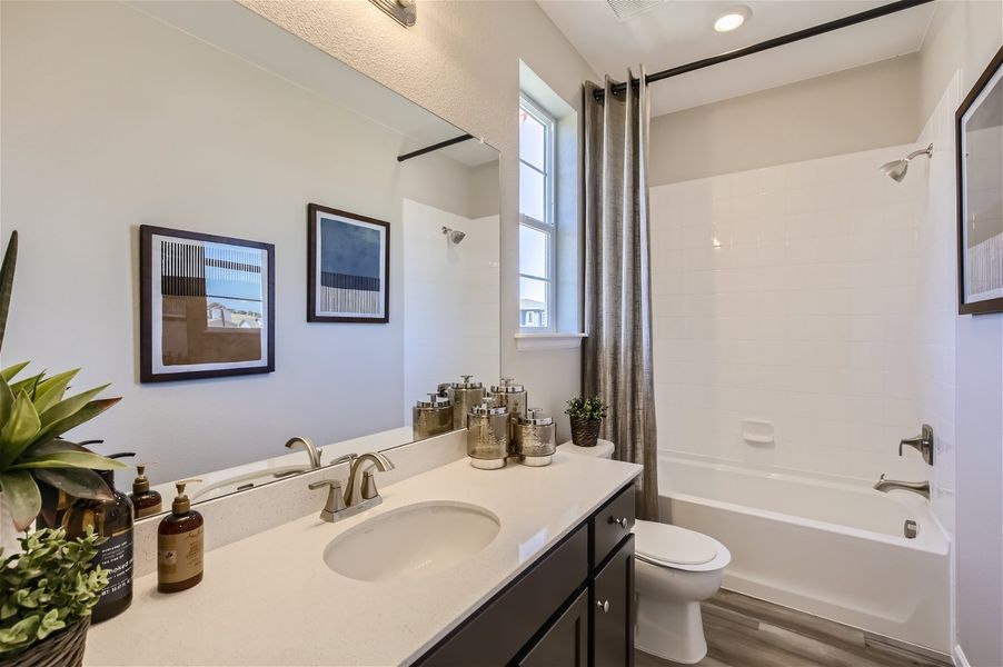 A bathroom with a tub sink and toilet. A bathroom with a tub sink and toilet.