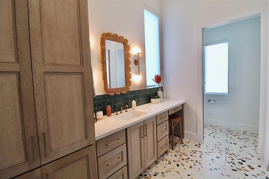 View of the secondary bathroom with ample storage.