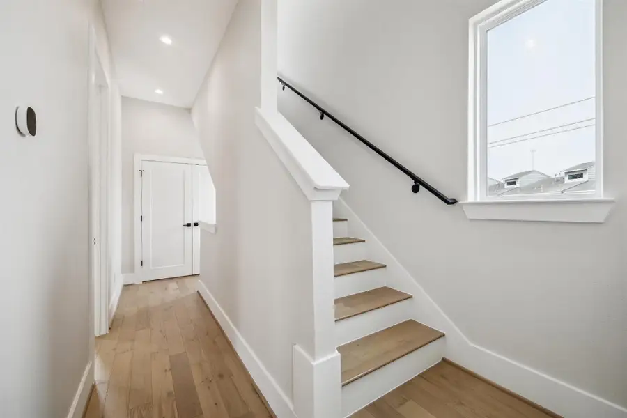 Door down the hallway from the primary leads to the utility room.