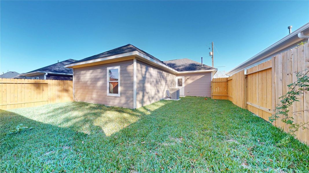 Exterior details and patio area of a home in East Gate Villas, Willis (Image 4).