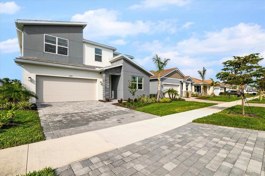 Front exterior of a new home in Sunstone at Wellen Park, Venice, FL, highlighting curb appeal (Image 21).