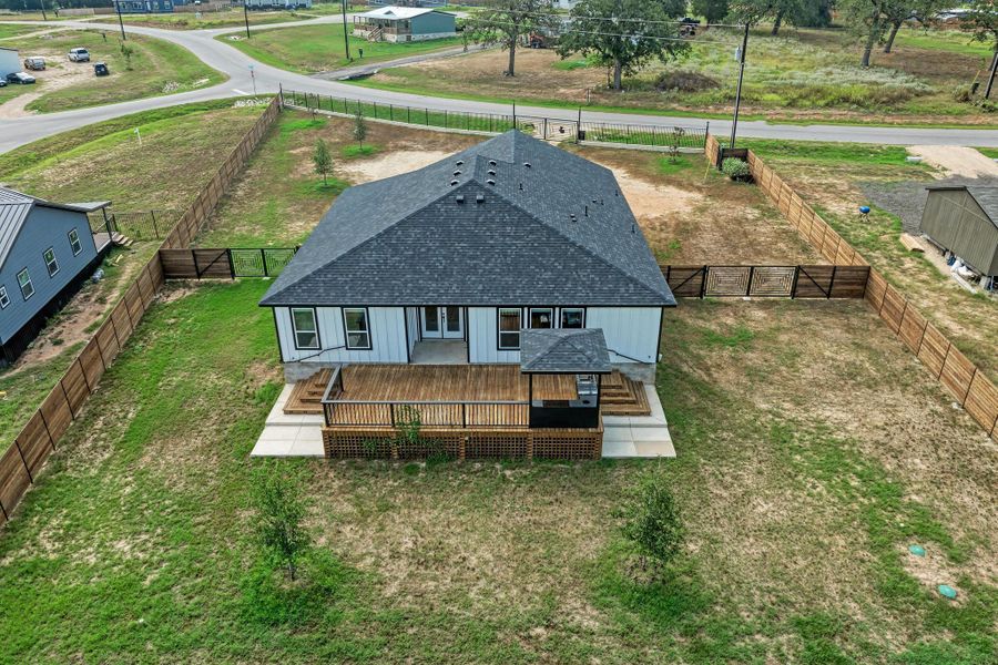 An expansive wooden deck overlooks the fully fenced backyard of this modern country home. An expansive wooden deck overlooks the fully fenced backyard of this modern country home.