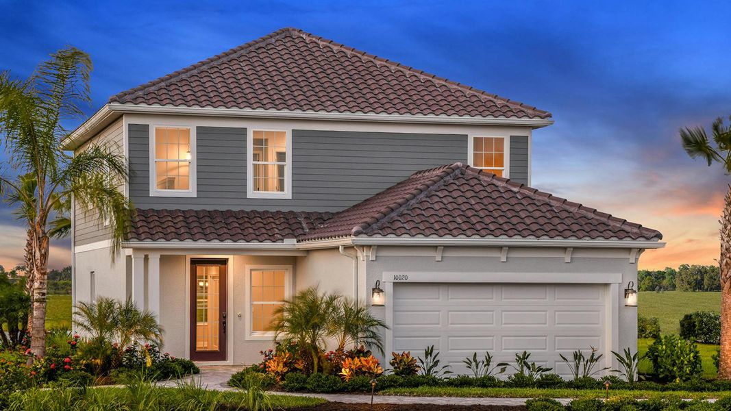 Front exterior of a new home in Grand Park Real Estate and Homes for Sale in Sarasota, FL - Neal Communities, Sarasota, FL, highlighting curb appeal (Image 24).