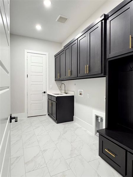 Washroom with sink, cabinets, and washer hookup