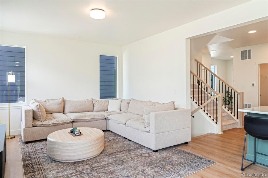 Inviting living room filled with natural light and soft finishes, offering a comfortable gathering space in this move-in ready Morrison Colorado home