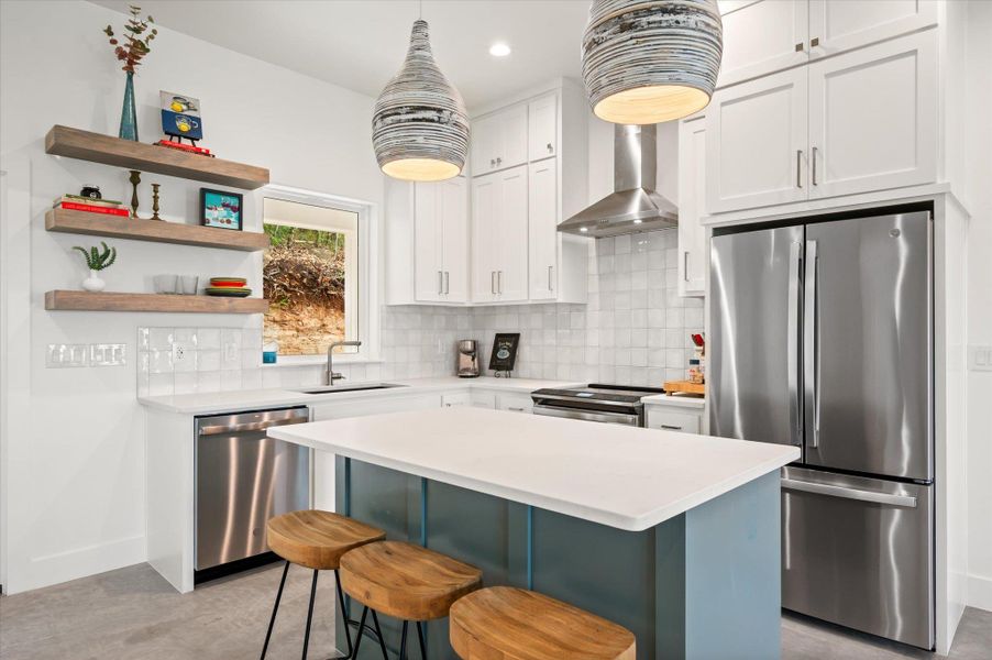 Open Kitchen with floor to ceiling custom cabinets with slow close doors and drawers, floating shelves and Savoy Lighing.