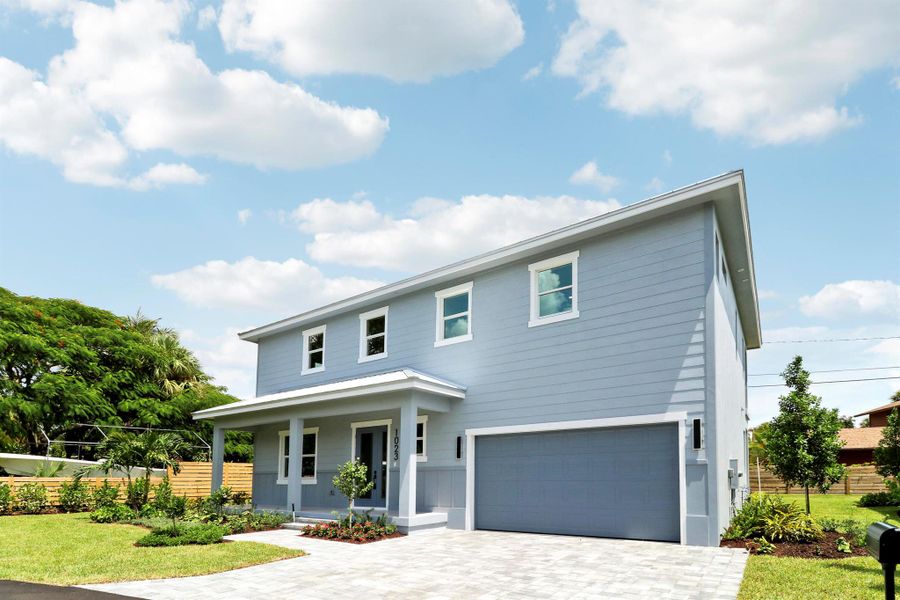 Front exterior of a new home in , Jensen Beach, FL, highlighting curb appeal (Image 1).