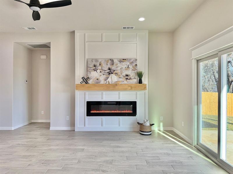 Unfurnished living room with light hardwood / wood-style floors and ceiling fan